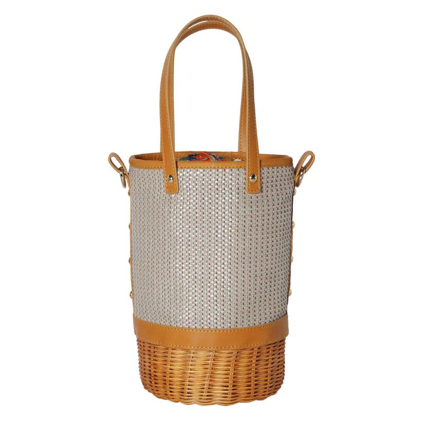 Tory Small Rattan Basket in Brown by Havana & Co. – Hand-woven rattan and raffia bag with leather details and colorful drawstring lining.