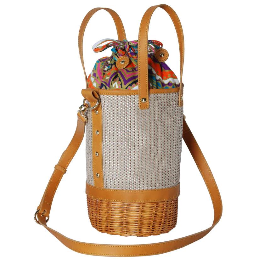 Tory Small Rattan Basket in Brown by Havana & Co. – Hand-woven rattan and raffia bag with leather details and colorful drawstring lining.