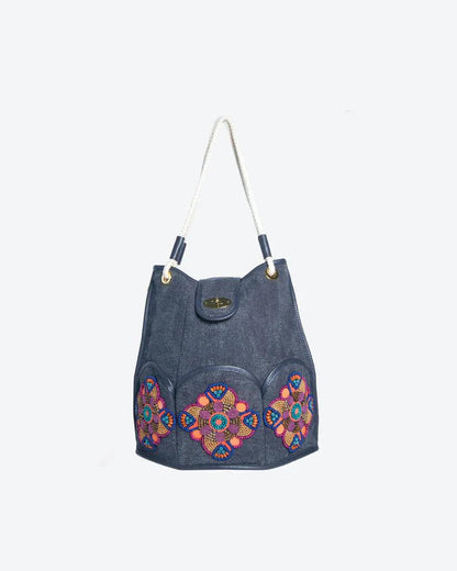 Marguerite Octagonal Bucket Bag by Havana & Co. – Distressed canvas with leather trim, six outer pockets, and handmade embellishments with sequins and beads.