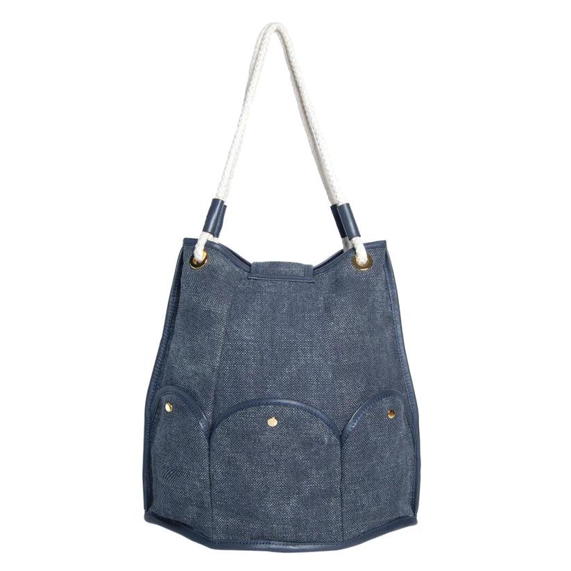 Marguerite Octagonal Bucket Bag by Havana & Co. – Distressed canvas with leather trim, six outer pockets, and handmade embellishments with sequins and beads.