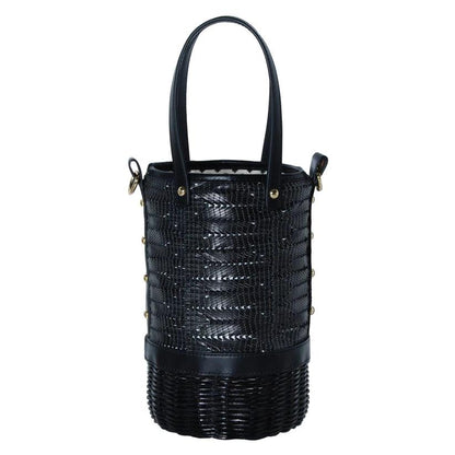 Tory Small Rattan Basket in Black by Havana & Co. – Hand-woven rattan and raffia bag with leather details and colorful drawstring lining.